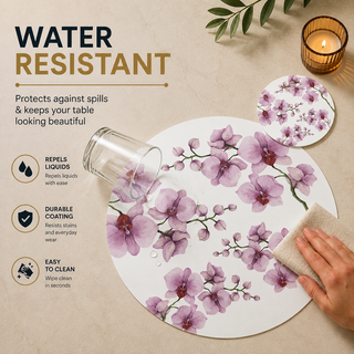 Orchid Reverie round paper placemat, pink and purple watercolor orchids, water resistant surface with liquid beading as a hand wipes it clean, matching coaster alongside