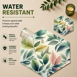 Pastel Foliage hexagonal paper placemat, soft pastel green and pink leaves, water resistant surface with liquid beading as a hand wipes it clean, matching coaster alongside