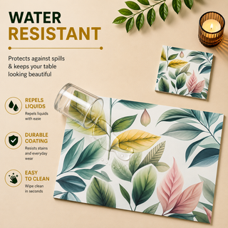 Pastel Foliage rectangular paper placemat, soft pastel green and pink leaves, water resistant surface with liquid beading as a hand wipes it clean, matching coaster alongside