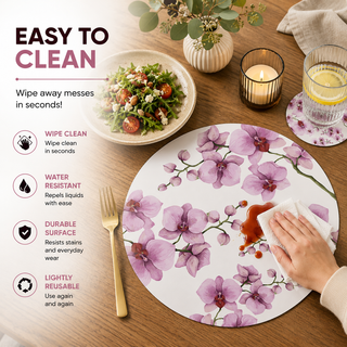 Orchid Reverie round paper placemat, pink and purple watercolor orchids, easy to clean as a hand wipes a spill beside a styled place setting