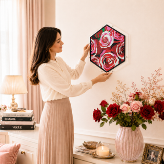 Person hanging the Rose Garden acrylic wall art puzzle on a living room wall