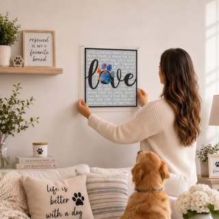 Person hanging the Paw & Love acrylic wall art puzzle on a living room wall