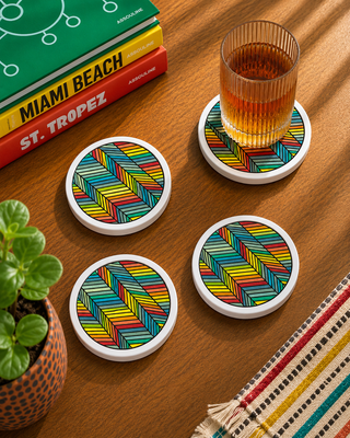 Finished Kinetic Rhythm hand painted ceramic coasters styled with drinks on a table