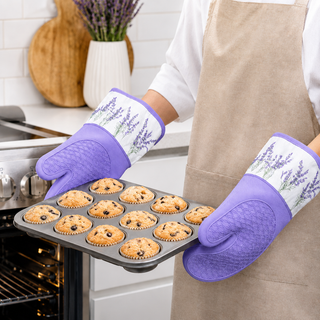 Lavender Breeze silicone oven mitts holding a hot baking tray from the oven